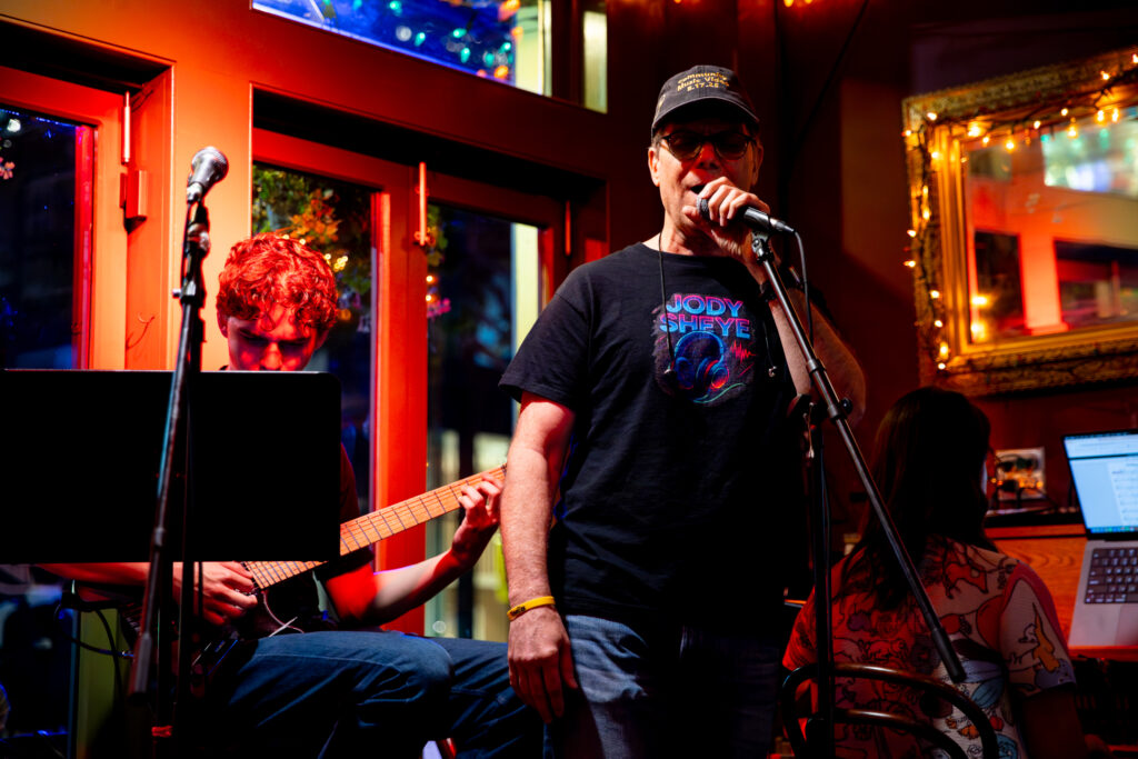 Doug, Luke, and Arabella singing and playing at the Bebop
